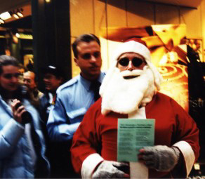 Santa Claus is escorted out of a mall by security